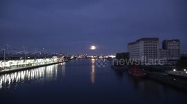 The October Full Moon known as the hunters Moon rises over the London City airport in London's Docklands