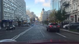 Emergency services rush to scene of missile strike on road in Kyiv
