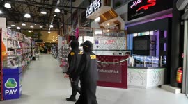 A Palestinian woman security, Reem Sukkar stands guard at a mall in Gaza City