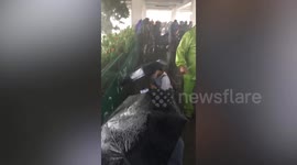 Tourists cower on footbridge during hailstorm in the Philippines