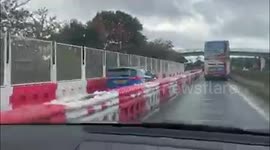 Hilarious footage shows a confused motorist cruising along barricaded section of dual carriage