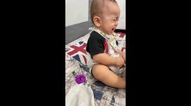 Technophobic tot cries at phone but smiles when handed books