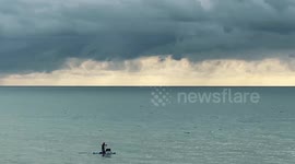 Sweet moment paddleboarder is spotted with dog in Brighton, England