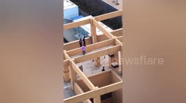 Pupils walk along beams on building's roof in terrifying footage captured in China