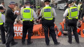 Just Stop Oil demonstrators throw soup and glue themselves outside BEIS in London