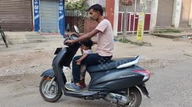 White cat in along a bike ride with very well blance and doesn't fall off