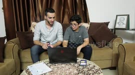 A Palestinian child Nour al-Din Fifil, 15, works on his lap-top at his home in Gaza City