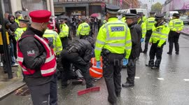 Police are separating the last two Just Stop Oil protesters who have their hands glued together in a metal pipe from Brompton Road next to Harrods department store in Knightsbridge.