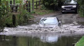 Idiotic! Driver ploughs into flooded ford and gets stuck during torrential rain in Birmingham, UK