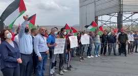 Protesters wave Palestinian flags and burn tires during a demonstration near the Hawara checkpoint against Israel's blockade in Nablus, in the West Bank