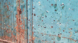 Palestinians gather around the damaged remains of a motorcycle