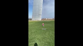 Little girl looks like an ant in front of the INSANELY GIGANTIC Gateway Arch