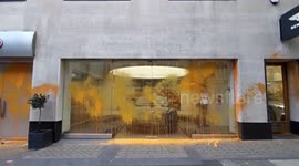 Bugatti showroom in Mayfair after being covered in Orange paint by Just Stop Oil