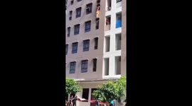 Lucky escape for woman hanging from the window of a fifth-floor apartment in Jakarta