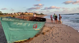 Sunrise Beach Walkers Perplexed by a Homemade Migrant Boat that Washed Ashore in Delray Beach, Florida