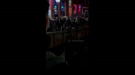 Curious bystanders cheer as man that fell into Amsterdam's canal is rescued