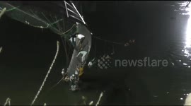 Survivors cling to collapsed bridge waiting to be rescued in India's Gujurat