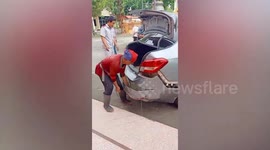 Bungling driver accidentally reverses up set of steps leaving himself stuck