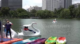 Locals take part in free water sports on lake in Bangkok, Thailand