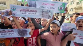 University students chant slogans and hold placards during a rally in support of the Palestinian armed group 