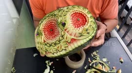 Chef sculpts three beautiful 3D chrysanthemum flowers on watermelon
