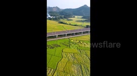 A Train Crossing Autumn Farmland in Nanning, China