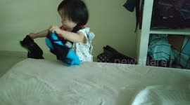 This little funny girl treats her dad's underwears as her toys