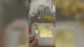 Meticulous worker sets gold leaf on paper by hand in Thailand