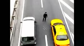 Man hands leaflets in the middle of a really busy road