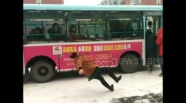 Commuter slips on icy ground after heavy snow