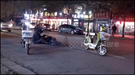 Drunk man lies on road before carried away by friends