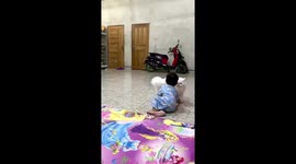 The little boy loves to play with the big white cat!