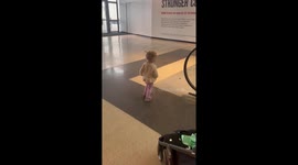 Baby girl proves herself a fast learner by mastering the art of... riding an escalator
