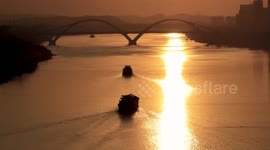Cargo Ships Sailing Over Qingchuan Bridge At Sunset in Nanning, China