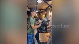 Showy waiter flips pot of biryani rice without spilling a grain