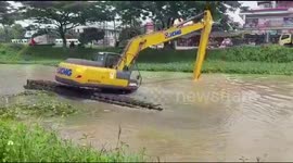 Digger overturns and sinks into river on the outskirts of Jakarta, Indonesia