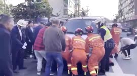 Firemen and residents lift truck up together to rescue elderly man trapped underneath in eastern China