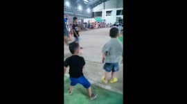 a two years young boy enjoying dance with a music in auditurium