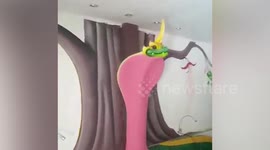 Weird hotel room has giant cobra statue towering over bed