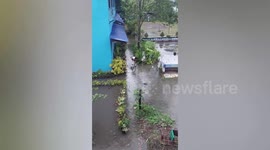 Clever student uses plastic chairs to cross flooded school garden