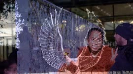 Visitors have fun at Winter Ice Festival which also features beautiful endangered animal sculpture in London's Canary Wharf