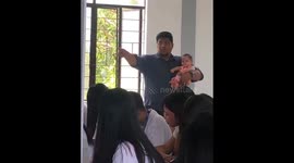 Heartwarming footage shows teacher taking care of student's child during exam