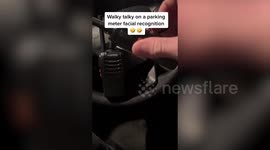 Prankster hilariously dupes woman into thinking parking meter uses facial recognition with walkie talkie prank