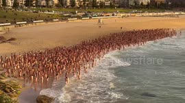Thousands go nude on Bondi beach for art and skin cancer awareness