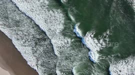 Aerial view of waves hitting the beach on the Oregon coast