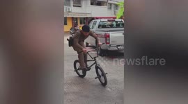 Talented cop shows off BMX riding skills at police station car park in Thailand