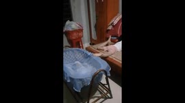 Eight-year-old sister uses her feet to lull her ten-month-old brother