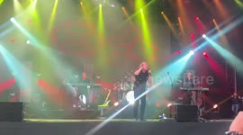 OMD in concert, group singing and playing music