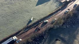 UK cold weather: Car skids on ice and crashes through bush into field