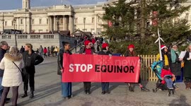 Climate activists sing Christmas carols in Trafalgar Square in protest against Rosebank oil and gas field